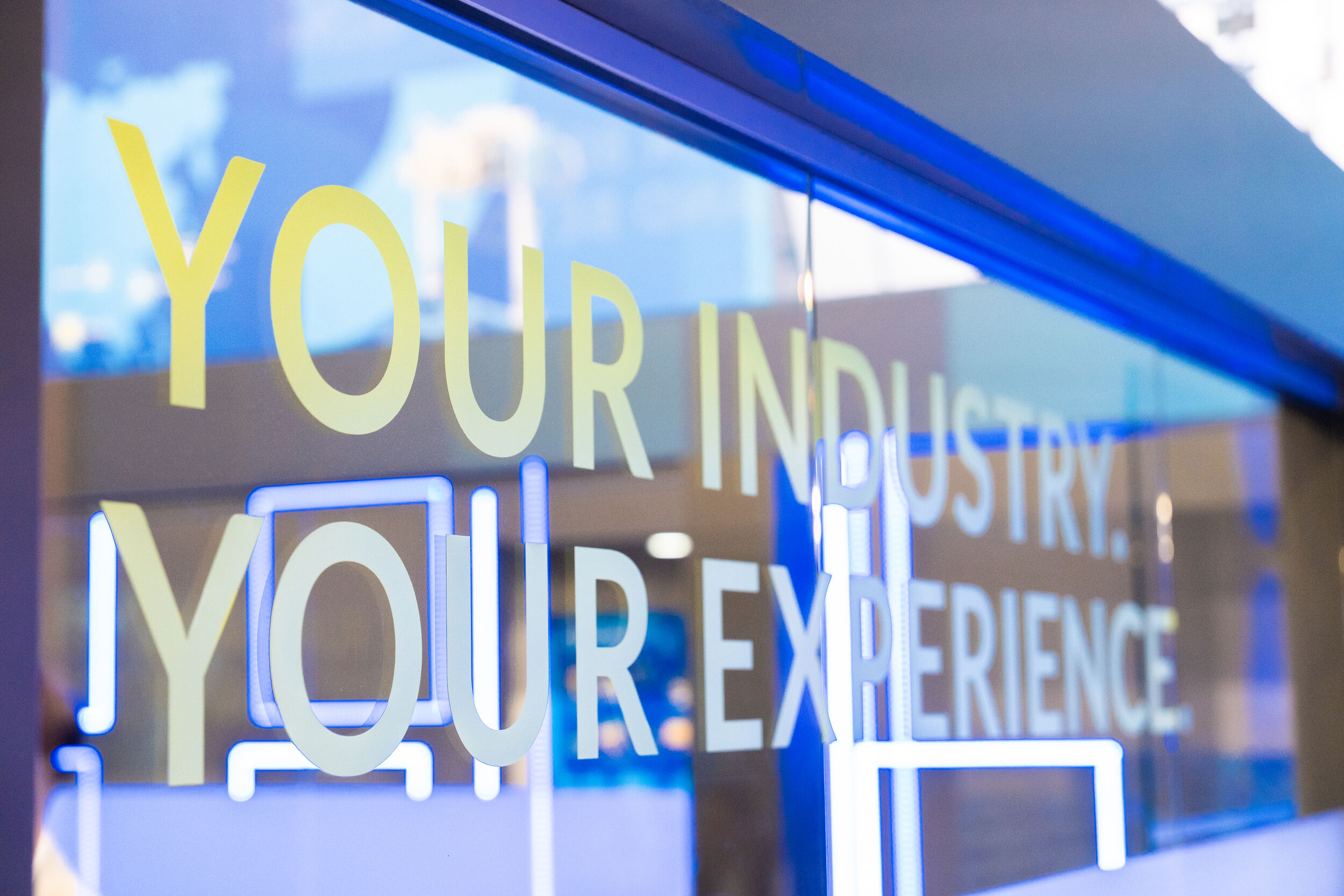 Werbespruch auf einer Glaswand beim Messestand der Theysohn Extrusionstechnik GmbH